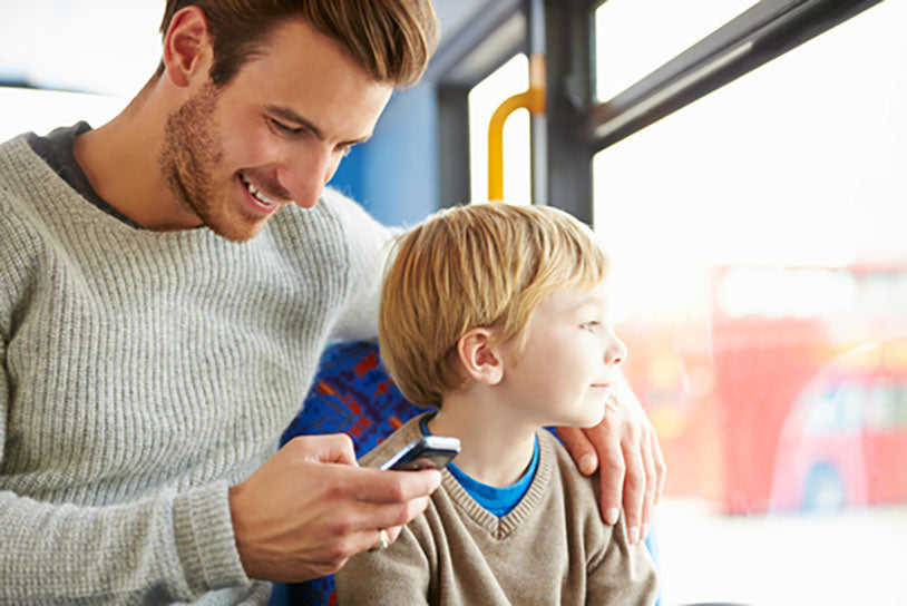 father son using mobile phone